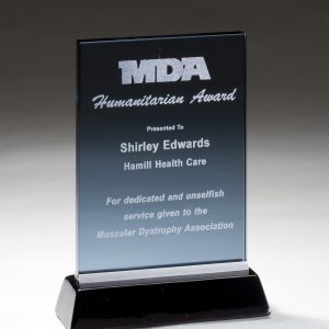 Smoked glass award mounted on a black base with brushed aluminum accents